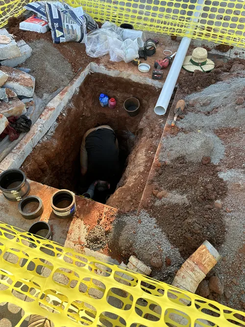 emergency plumber fixing blocked drain in Zillmere