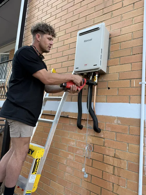 gas hot water system being repaired at a home in Everton Park